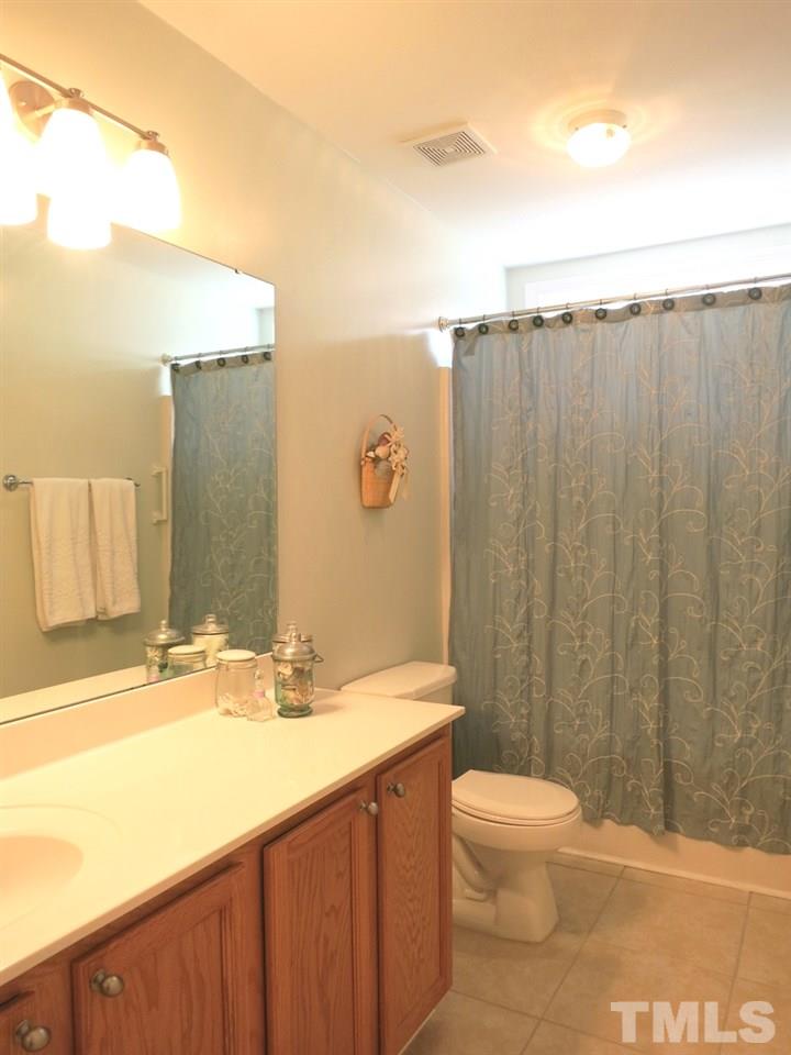 4629 Landover Crest Drive Raleigh, NC 27616 - Photo 19 of 25 The 3 addl Bedrooms share the lg Hall Bath w/tile floor, long vanity & linen closet; nearby is the convenient 2nd floor Laundry closet w/shelving.