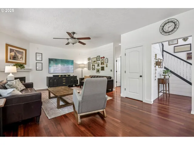 a workspace with wooden floor and a ceiling fan