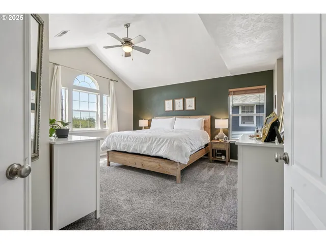 a bedroom with a bed couch and window