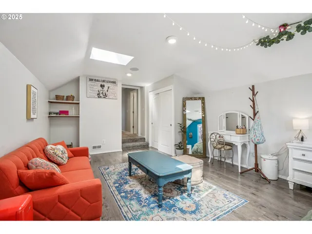 a living room with furniture a rug and a chandelier