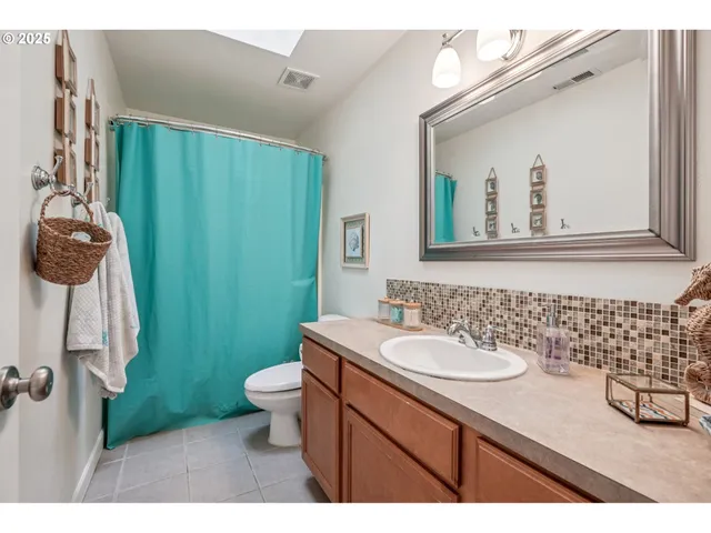 a bathroom with a sink a toilet and mirror