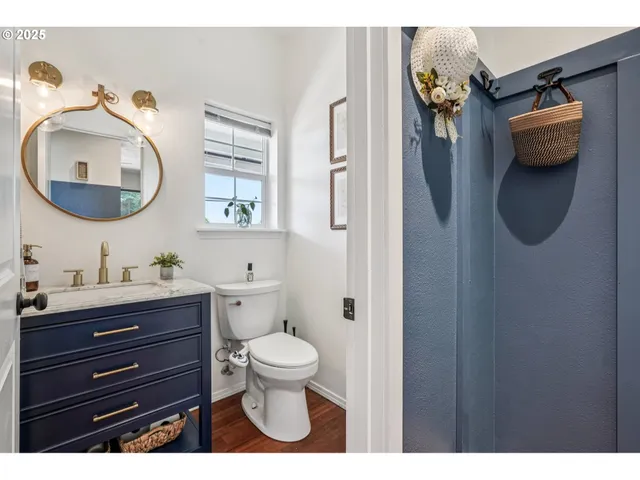 a bathroom with a toilet sink and mirror