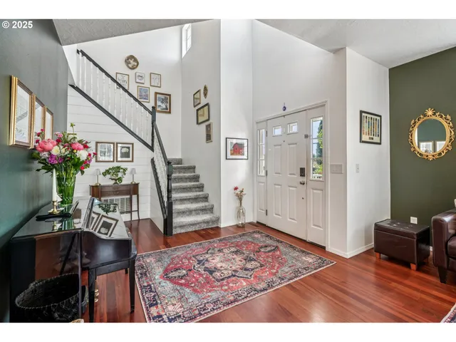 a bedroom with furniture and a wooden floor