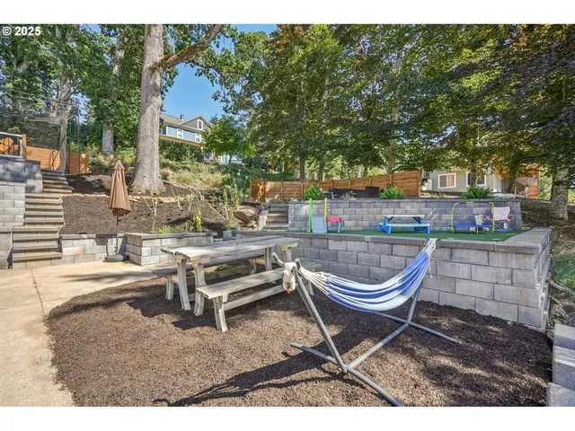a backyard of a house with barbeque oven table and chairs
