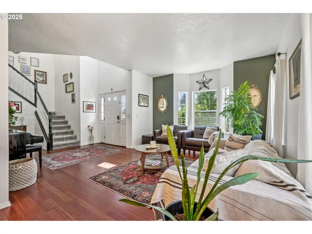 a view of a livingroom with furniture and floor to ceiling windows