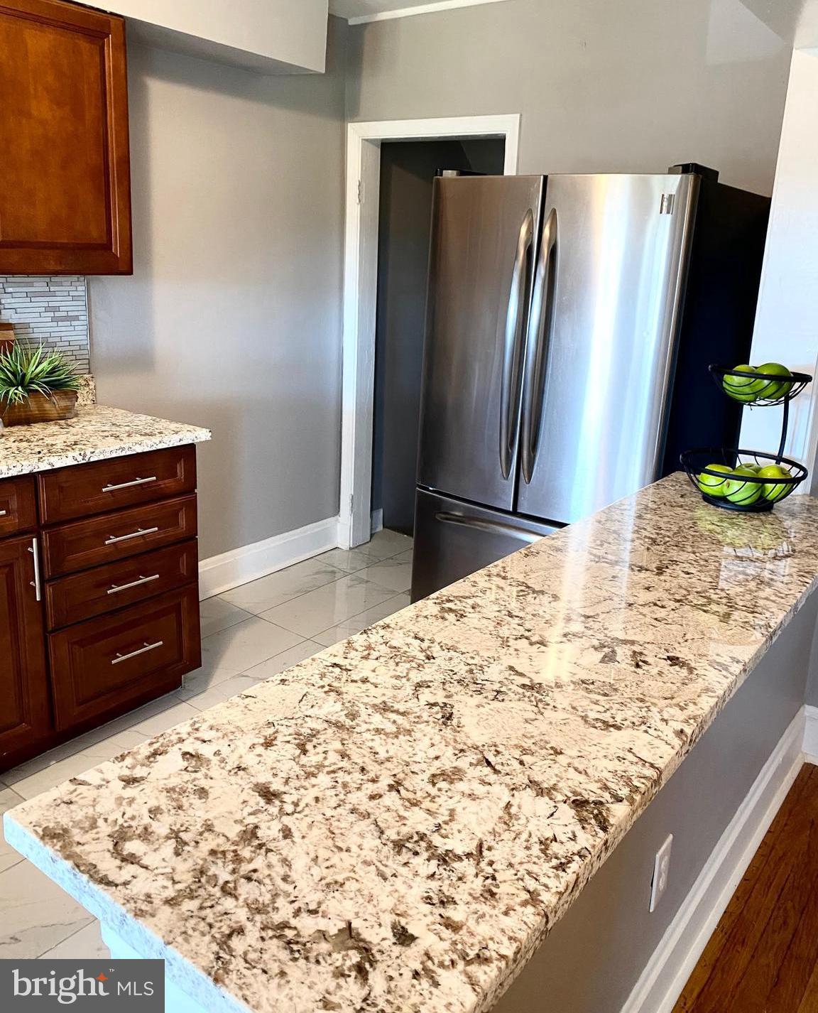 5019 Schaub Avenue Baltimore, MD 21206 - Photo 14 of 34 a bathroom with a granite countertop sink and a mirror