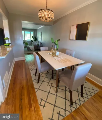a view of a dining room with furniture and chandelier