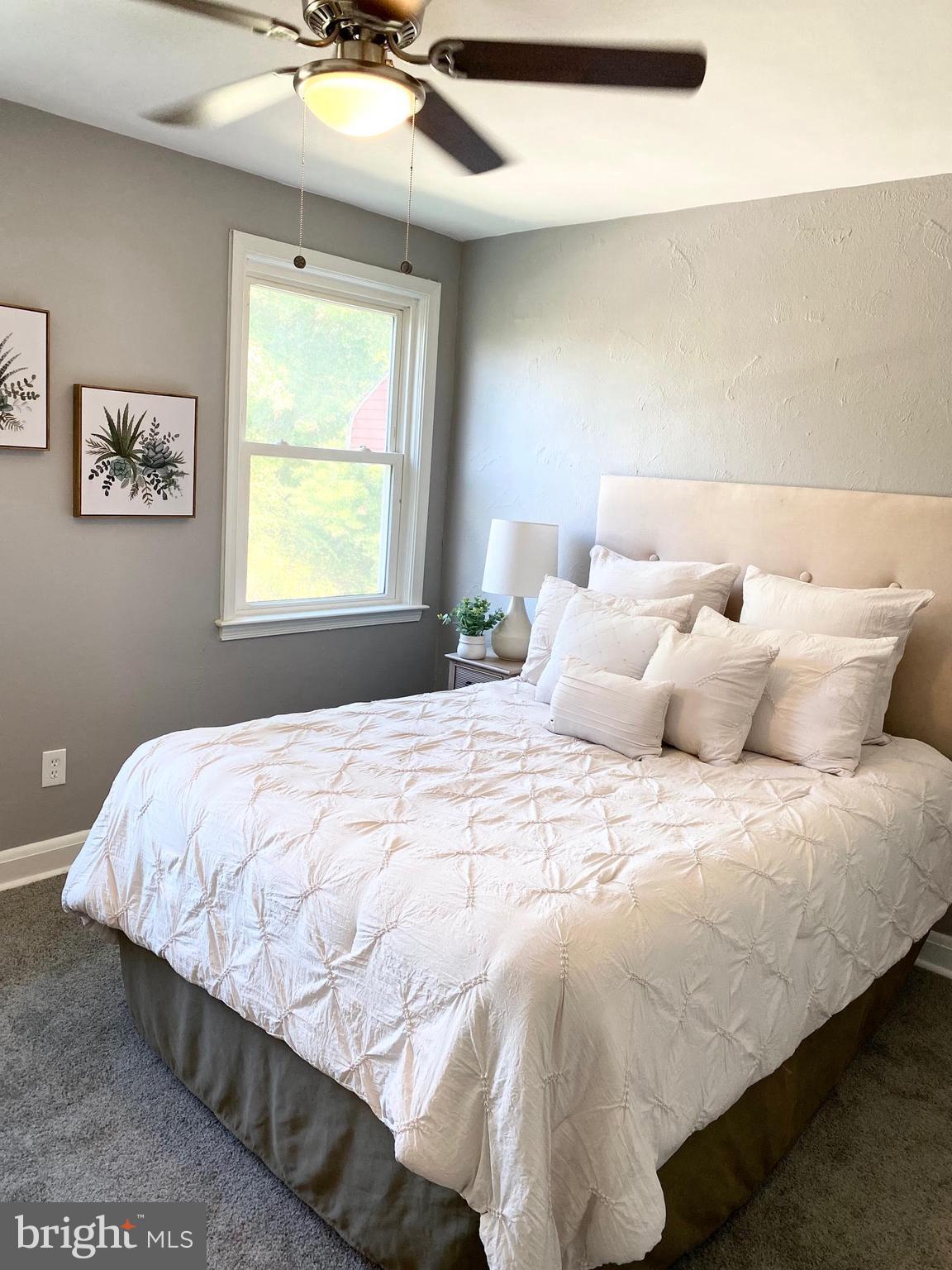 5019 Schaub Avenue Baltimore, MD 21206 - Photo 20 of 34 a bedroom with a bed and a chandelier