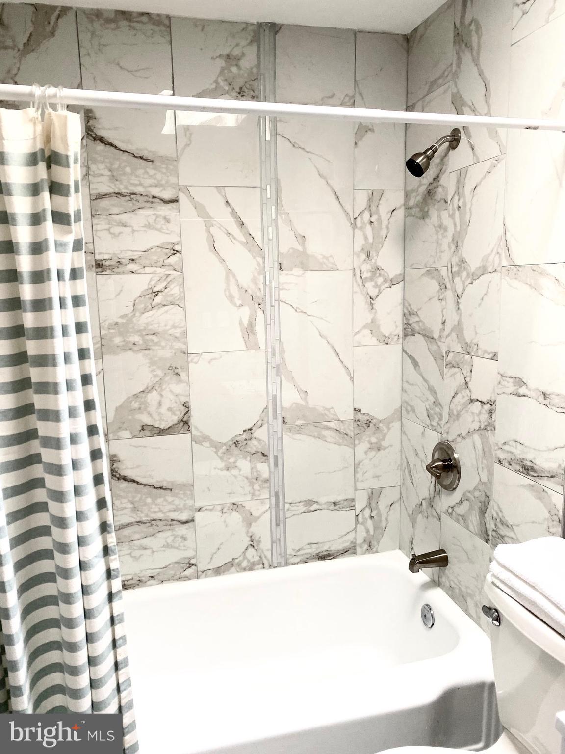 5019 Schaub Avenue Baltimore, MD 21206 - Photo 22 of 34 a bathroom with a bathtub and shower