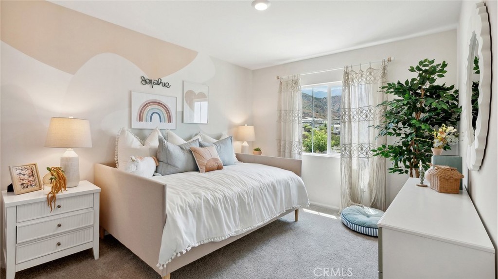 11392 Forge Road Corona, CA 92883 - Photo 19 of 24 a bedroom with a bed and a potted plant