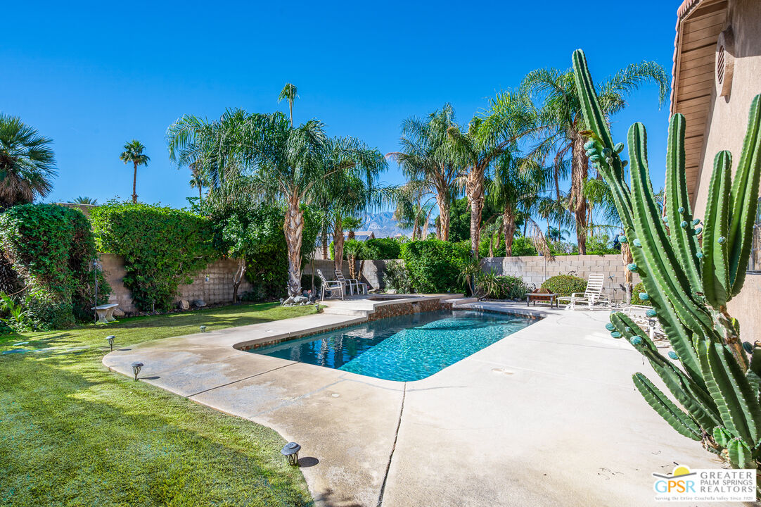 68655 Durango Road Cathedral City, CA 92234 - Photo 1 of 36 a view of a swimming pool with a garden