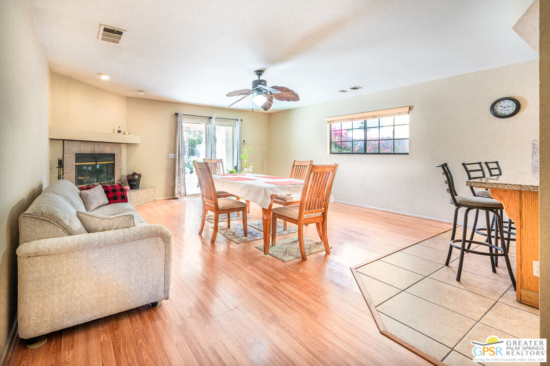 68655 Durango Road Cathedral City, CA 92234 - Photo 16 of 36 a living room with furniture a dining table and a fireplace