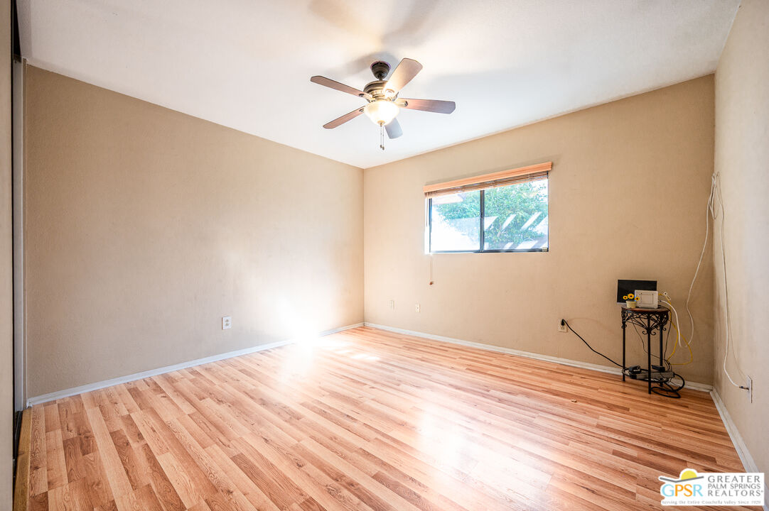 68655 Durango Road Cathedral City, CA 92234 - Photo 21 of 36 a view of empty room with wooden floor and fan