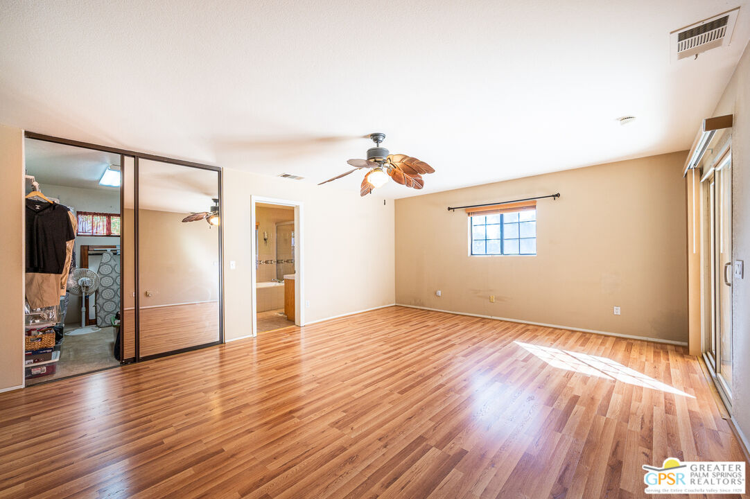68655 Durango Road Cathedral City, CA 92234 - Photo 22 of 36 a view of empty room with wooden floor and window