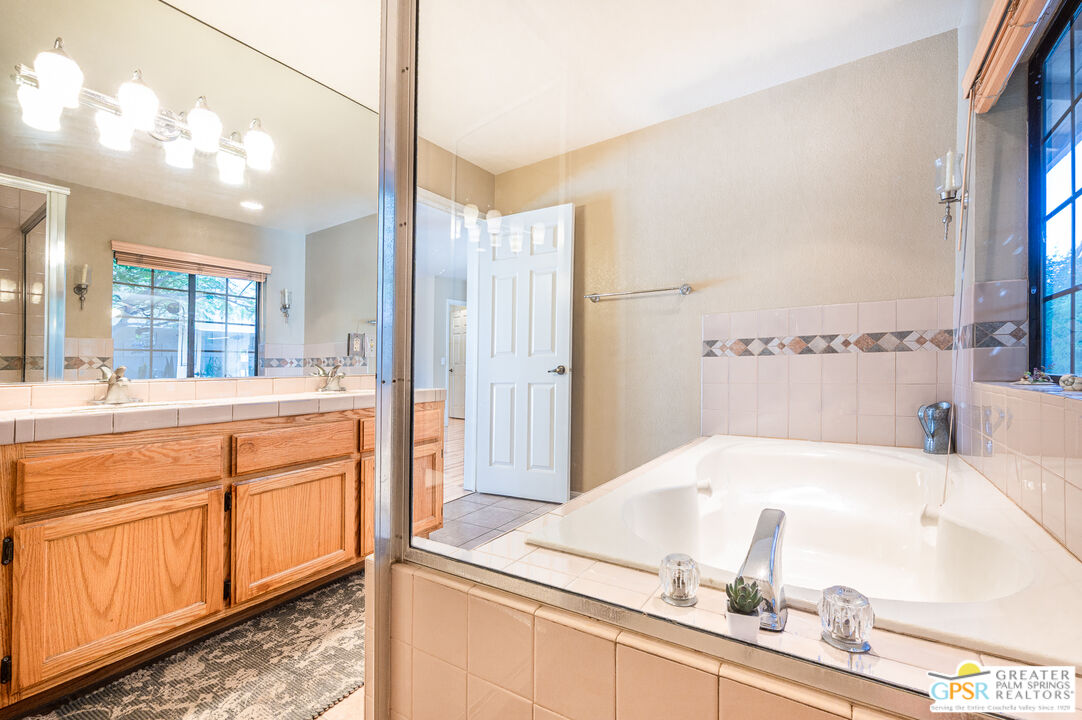 68655 Durango Road Cathedral City, CA 92234 - Photo 24 of 36 a bathroom with a tub sink and mirror