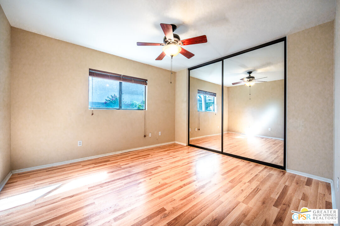 68655 Durango Road Cathedral City, CA 92234 - Photo 26 of 36 a view of an empty room with wooden floor and a window