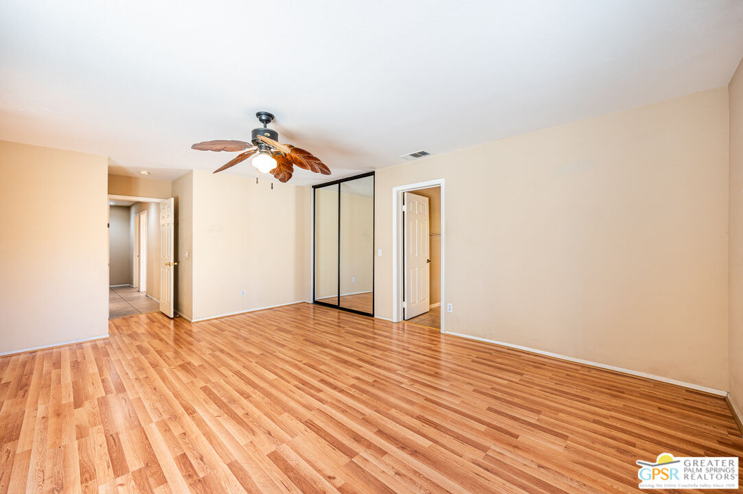 68655 Durango Road Cathedral City, CA 92234 - Photo 27 of 36 a view of a livingroom with wooden floor and a ceiling fan