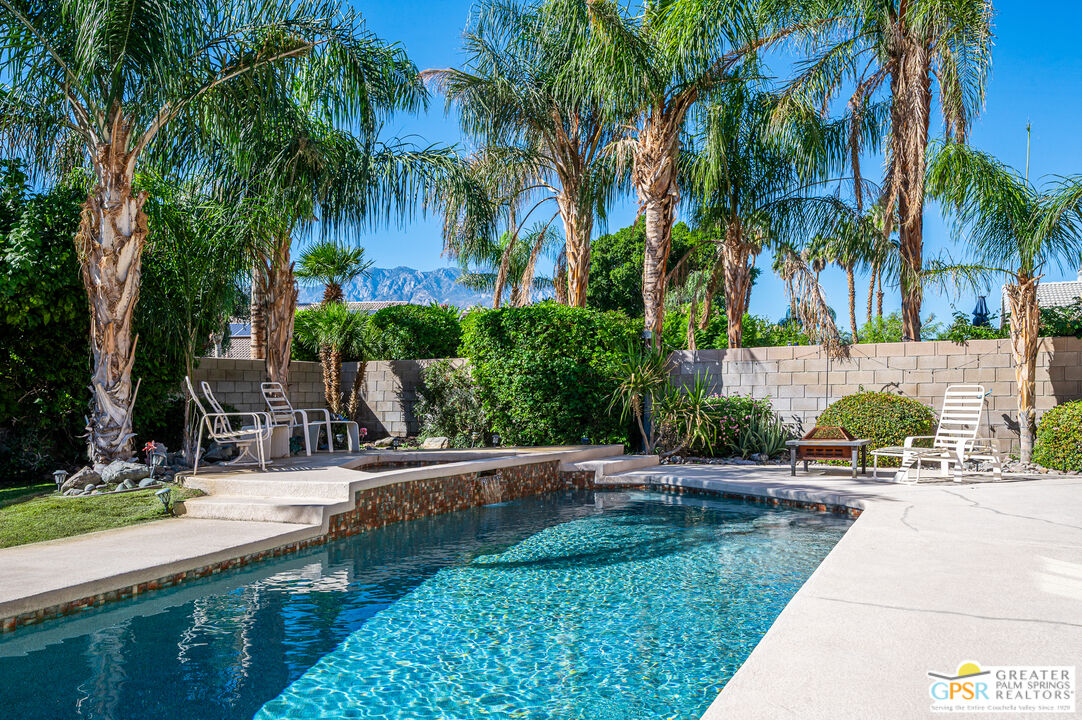 68655 Durango Road Cathedral City, CA 92234 - Photo 32 of 36 a view of a swimming pool with a garden