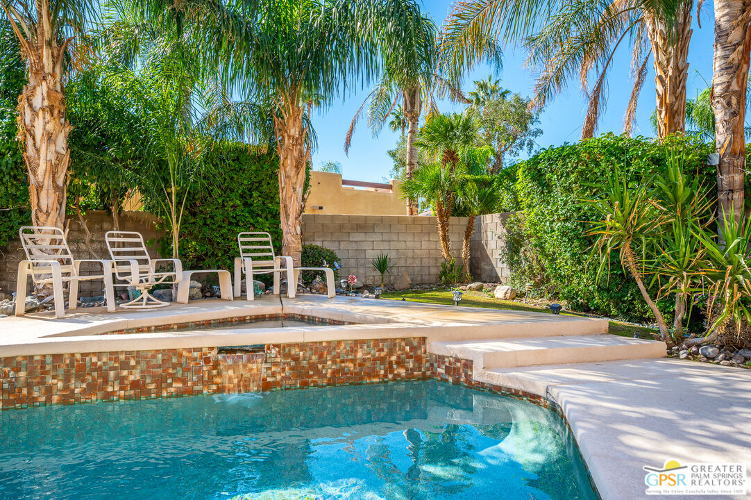 68655 Durango Road Cathedral City, CA 92234 - Photo 35 of 36 a view of a swimming pool with a yard and palm trees