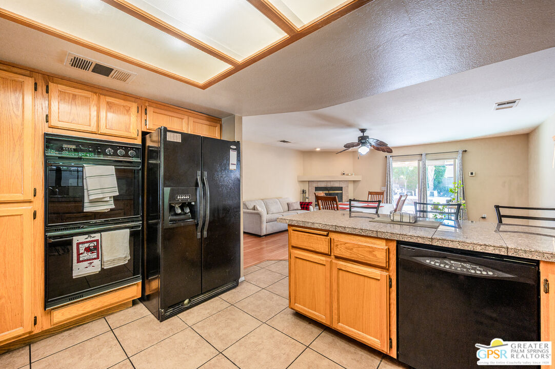 68655 Durango Road Cathedral City, CA 92234 - Photo 9 of 36 a kitchen with stainless steel appliances granite countertop a refrigerator and a stove top oven
