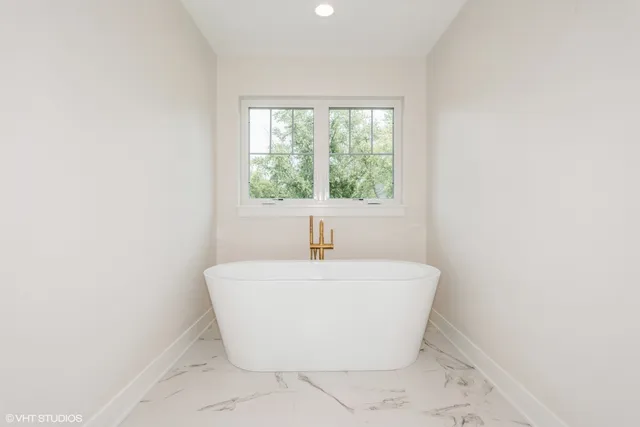 a white bath tub sitting in a bathroom