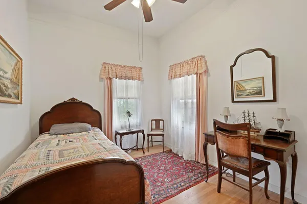 a view of an empty room with a fireplace and a window