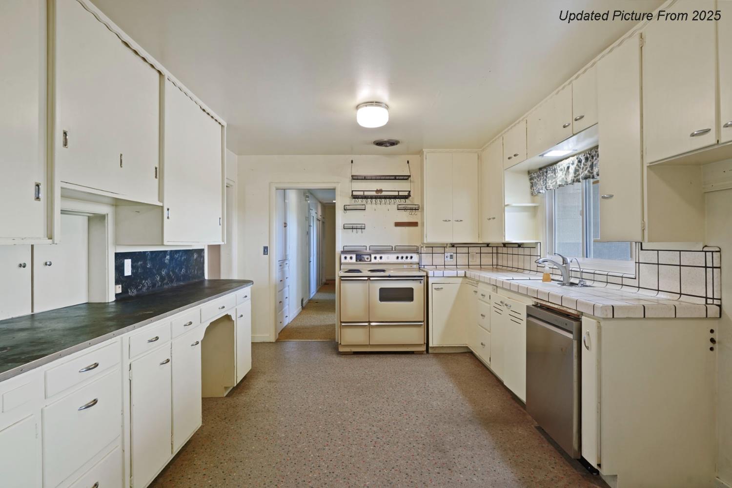 39670 South River Road Clarksburg, CA 95612 - Photo 69 of 85 a kitchen with granite countertop white cabinets and white appliances