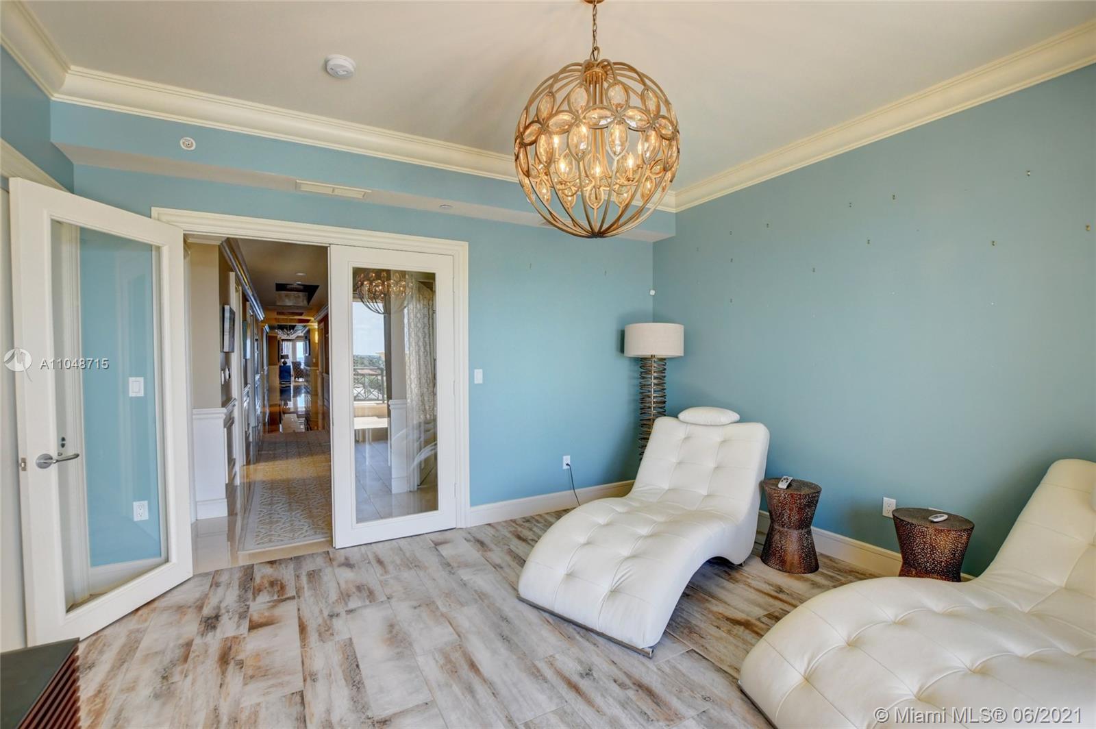 2500 South Ocean Boulevard, Unit 702 Boca Raton, FL 33432 - Photo 16 of 61 a bedroom with bed and a chandelier