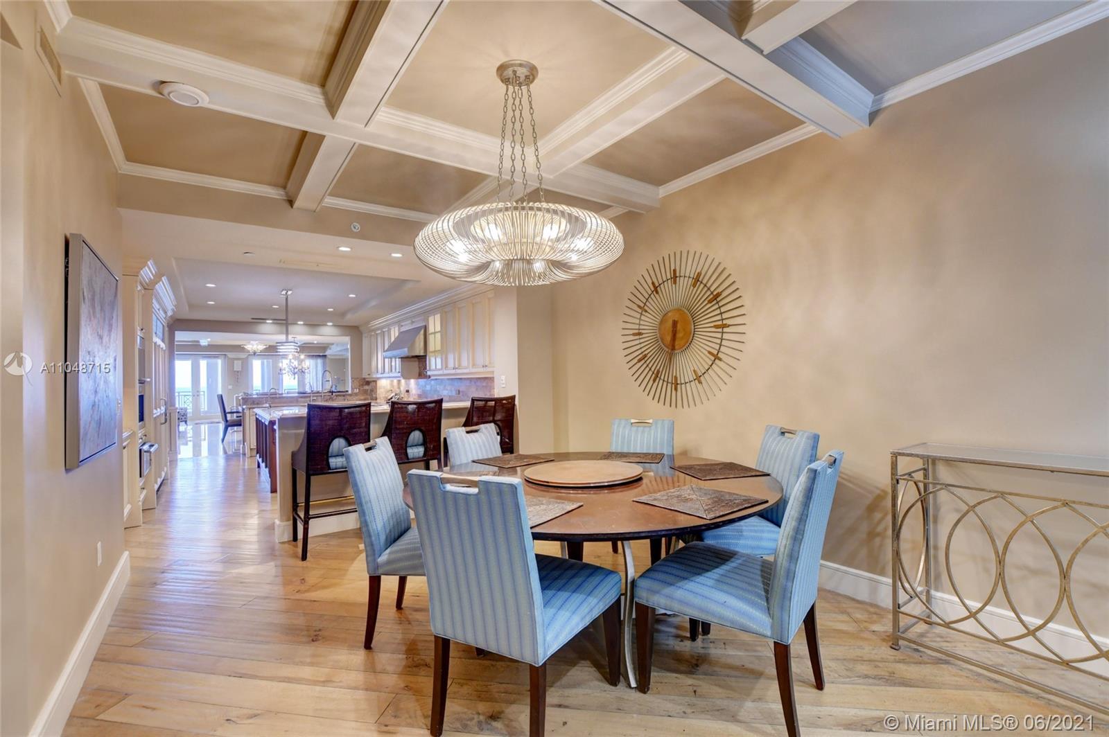 2500 South Ocean Boulevard, Unit 702 Boca Raton, FL 33432 - Photo 24 of 61 a view of a dining room with furniture a chandelier and wooden floor
