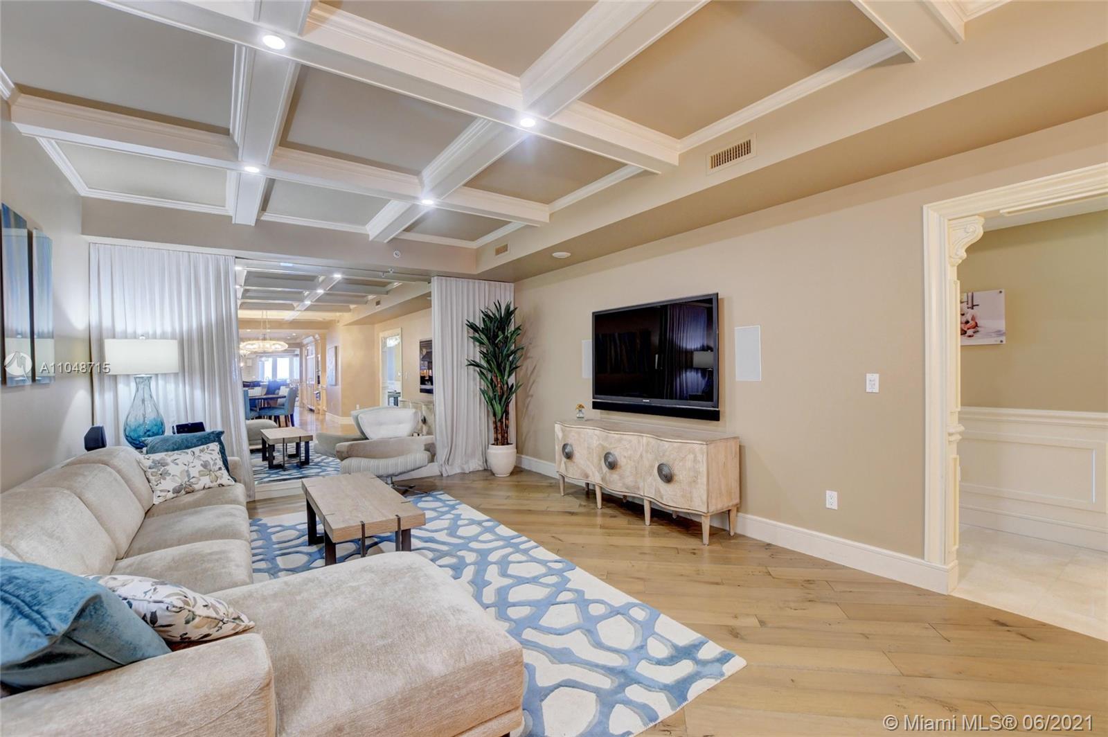 2500 South Ocean Boulevard, Unit 702 Boca Raton, FL 33432 - Photo 28 of 61 a living room with furniture and a flat screen tv