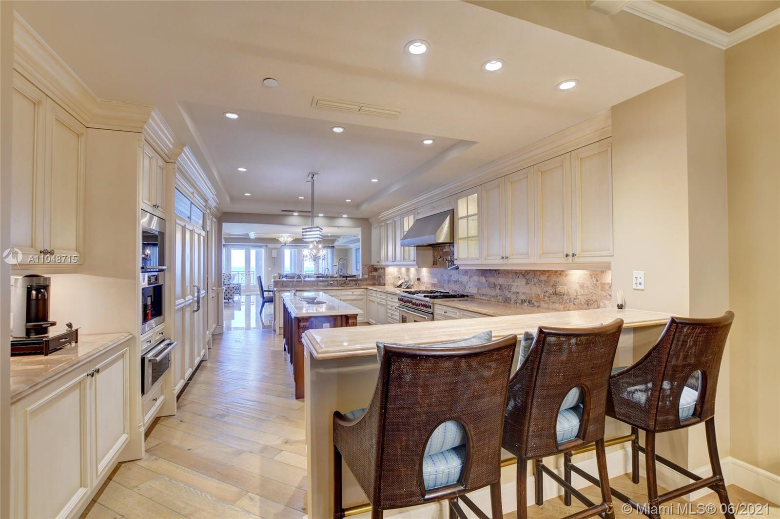 2500 South Ocean Boulevard, Unit 702 Boca Raton, FL 33432 - Photo 29 of 61 a large kitchen with a table and chairs