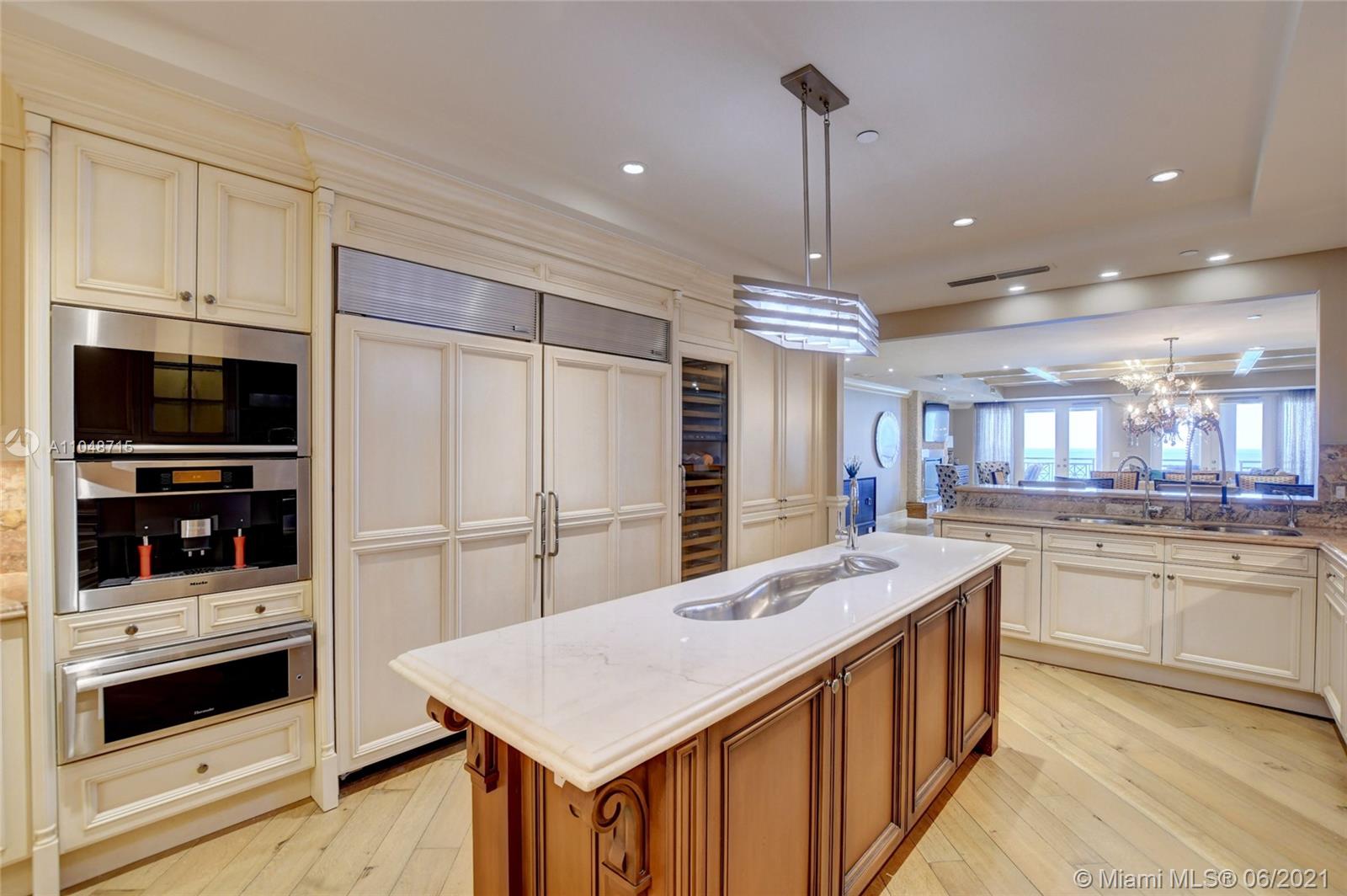2500 South Ocean Boulevard, Unit 702 Boca Raton, FL 33432 - Photo 33 of 61 a kitchen with stainless steel appliances kitchen island granite countertop a refrigerator and a stove top oven