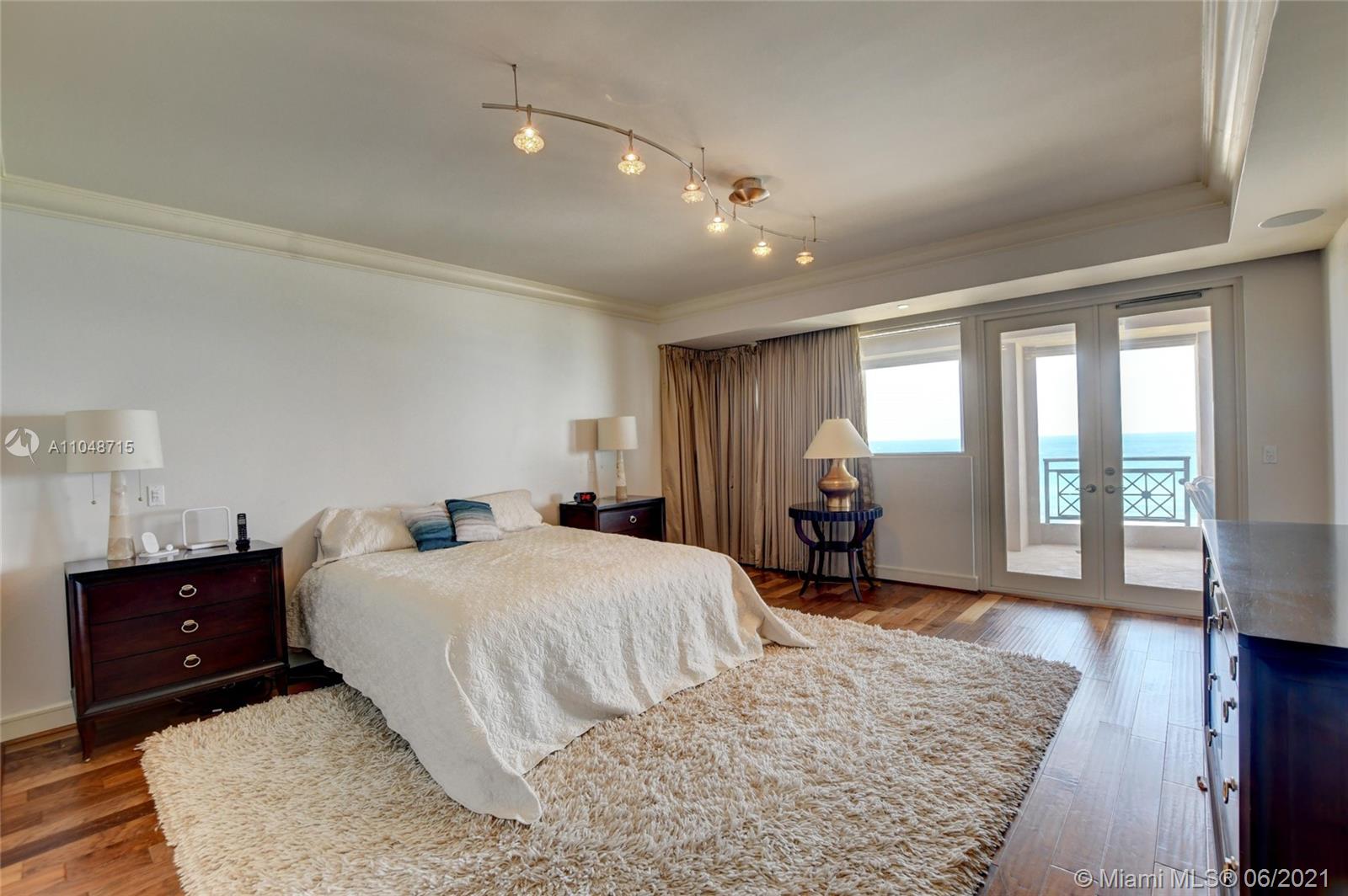 2500 South Ocean Boulevard, Unit 702 Boca Raton, FL 33432 - Photo 35 of 61 a bedroom with a bed and wooden floor