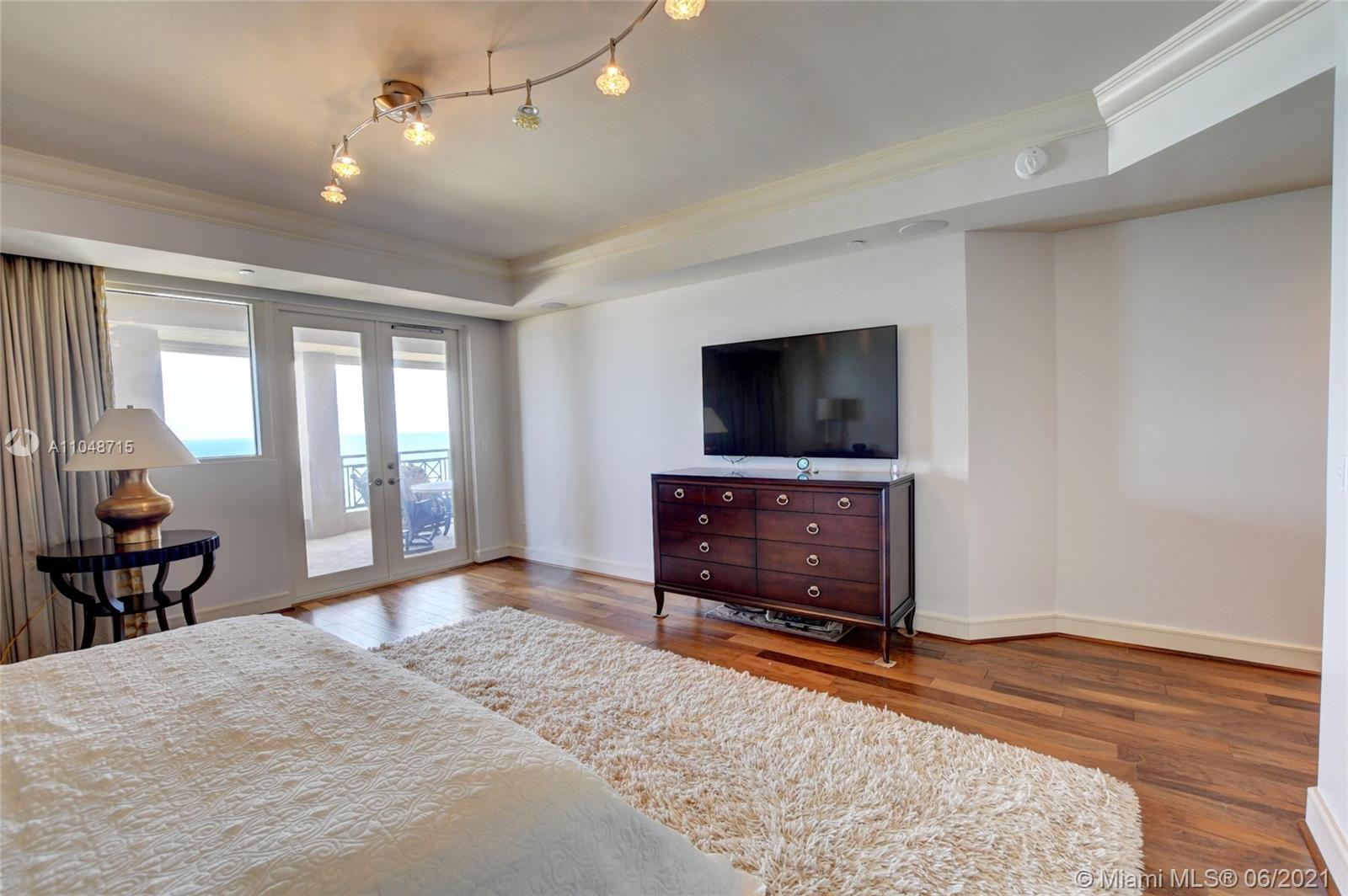 2500 South Ocean Boulevard, Unit 702 Boca Raton, FL 33432 - Photo 36 of 61 a bedroom with furniture and flat screen tv