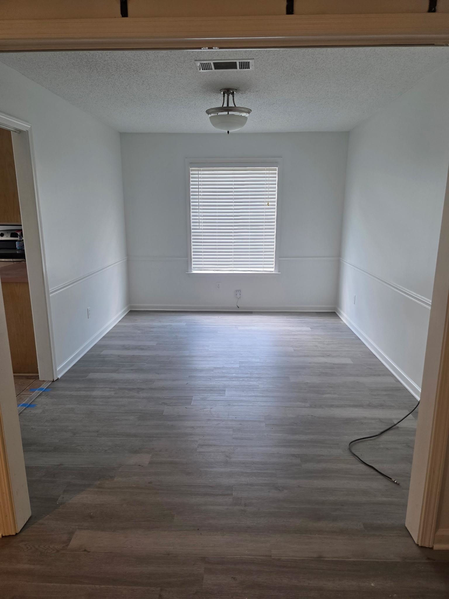 1441 Milestone Drive Collierville, TN 38017 - Photo 11 of 16 a view of an empty room with wooden floor and a window