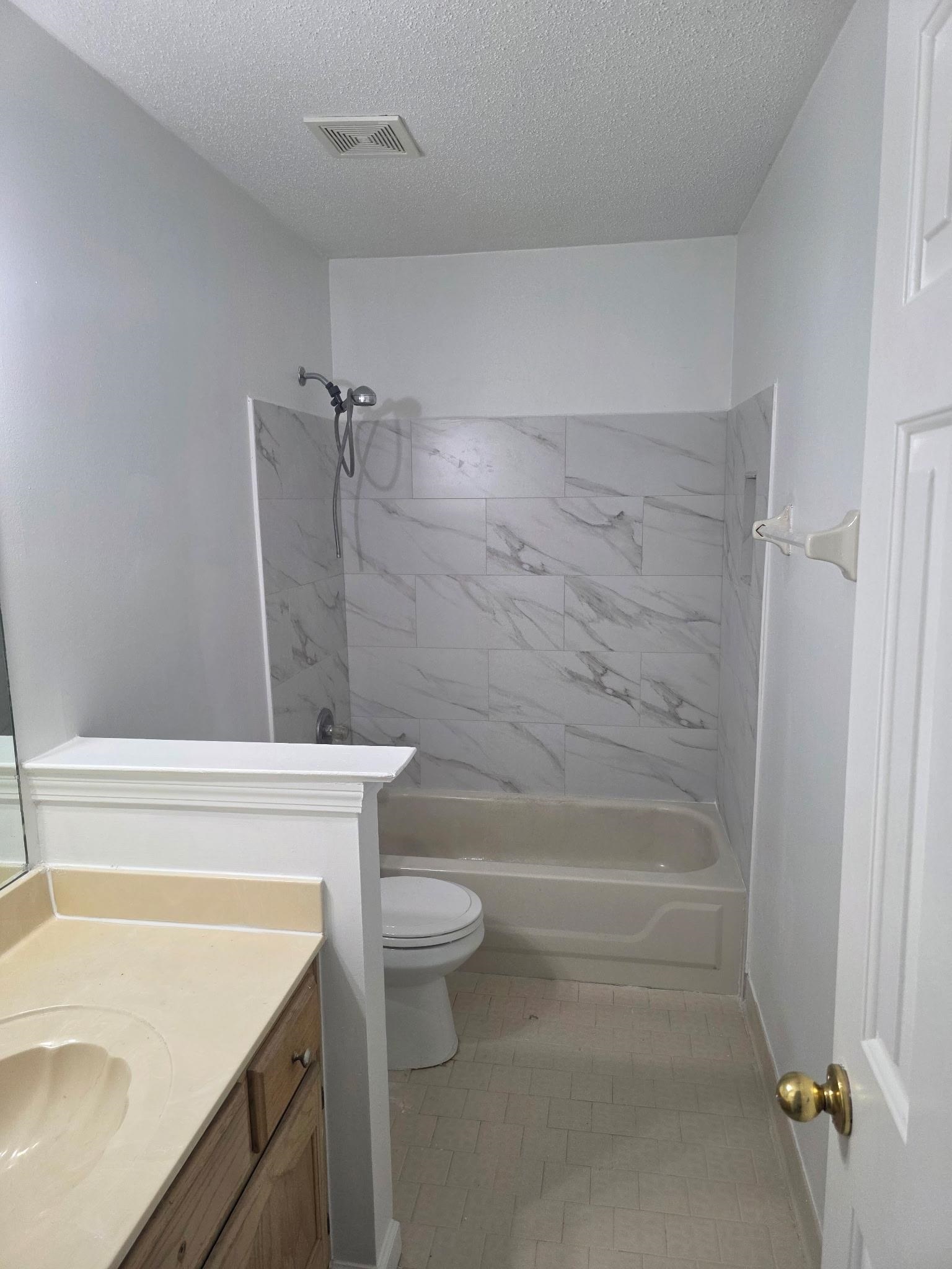 1441 Milestone Drive Collierville, TN 38017 - Photo 12 of 16 a bathroom with a sink a toilet and bathtub