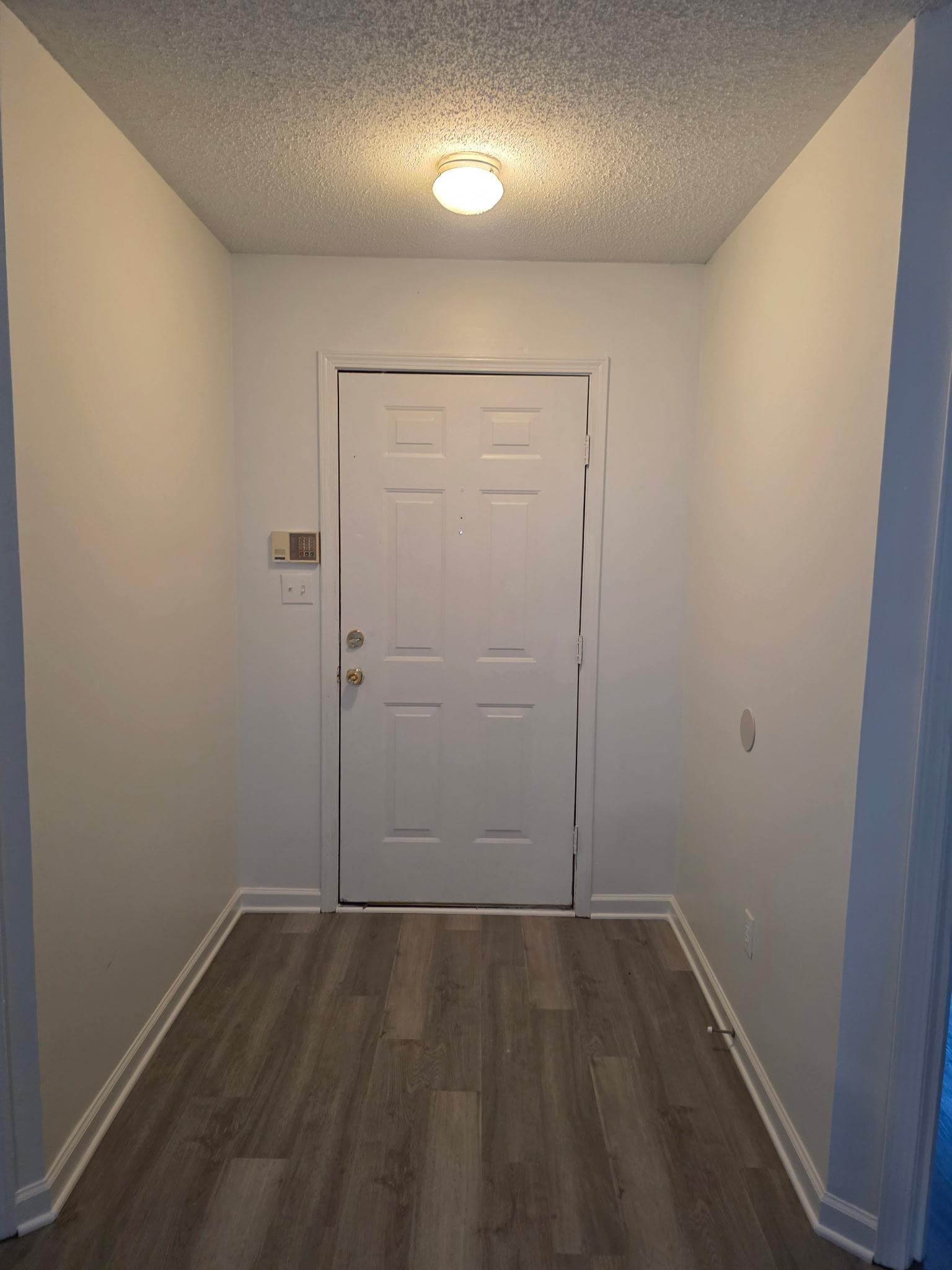 1441 Milestone Drive Collierville, TN 38017 - Photo 2 of 16 an empty room with wooden floor and mirror