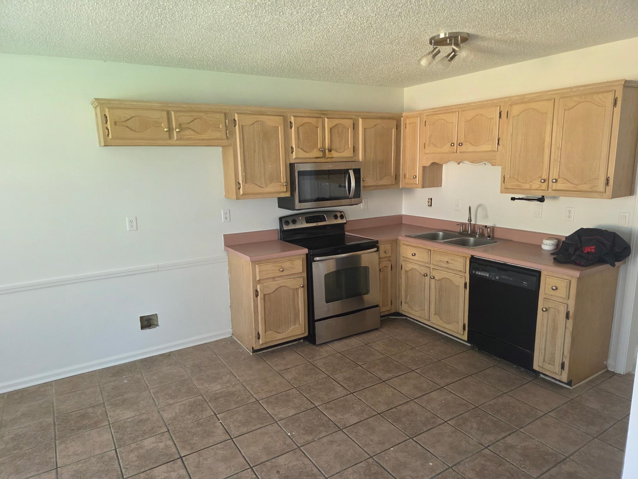 1441 Milestone Drive Collierville, TN 38017 - Photo 6 of 16 a kitchen with a sink stove top oven and cabinets