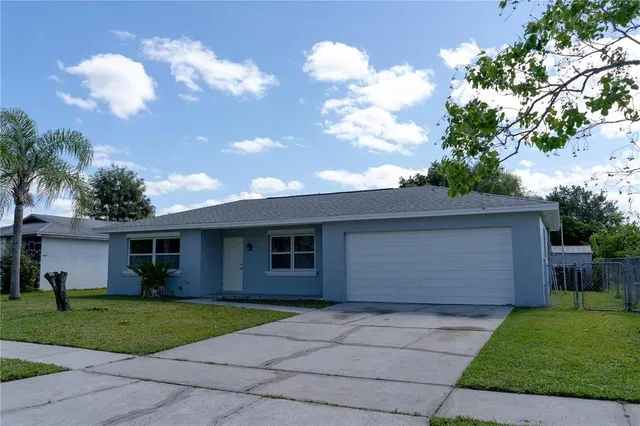a front view of house with a garden