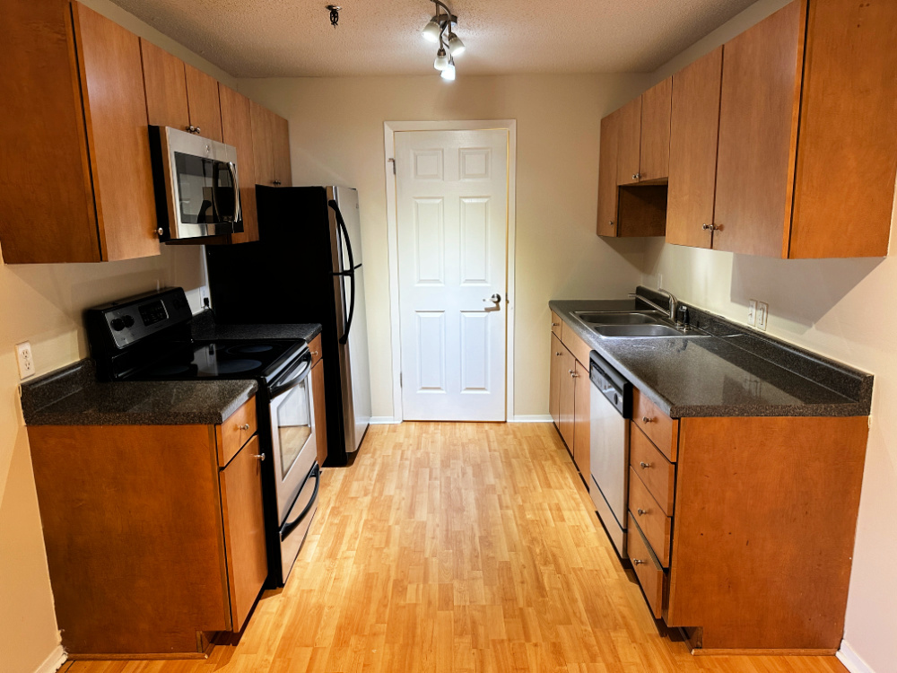 1350 Brook Street, Unit K St. Charles, IL 60174 - Photo 2 of 12 a kitchen with granite countertop a sink appliances and cabinets