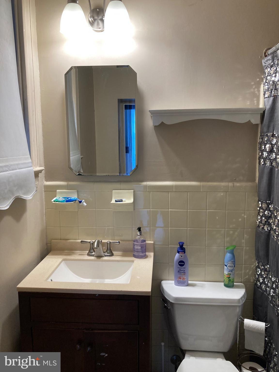 1338 Wisconsin Avenue Northwest, Unit 2 Washington, DC 20007 - Photo 9 of 11 a bathroom with a toilet sink and mirror