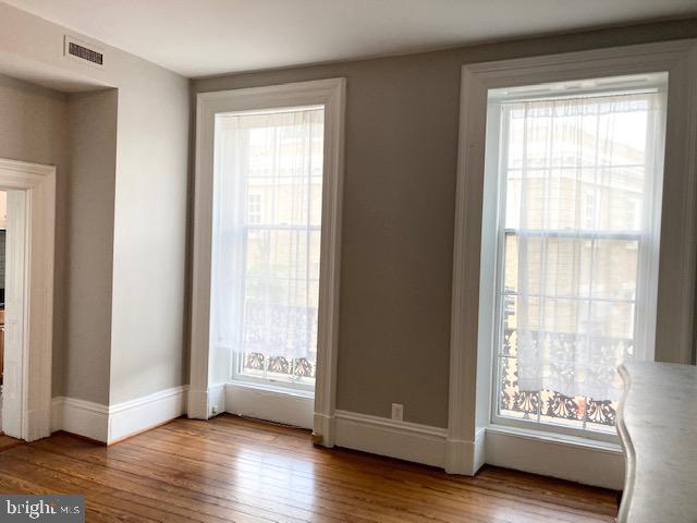 1338 Wisconsin Avenue Northwest, Unit 2 Washington, DC 20007 - Photo 10 of 11 a view of an empty room with wooden floor and a window