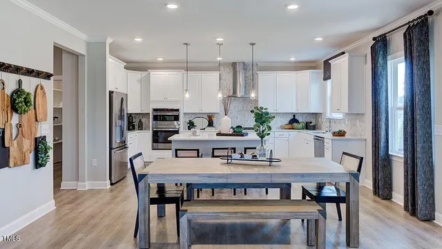 a bathroom with a double vanity sink mirror and bathtub