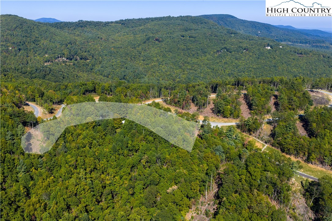 Lot 137 Angelfire Trail Deep Gap, NC 28618 - Photo 16 of 27 a view of a lush green forest with trees and some houses