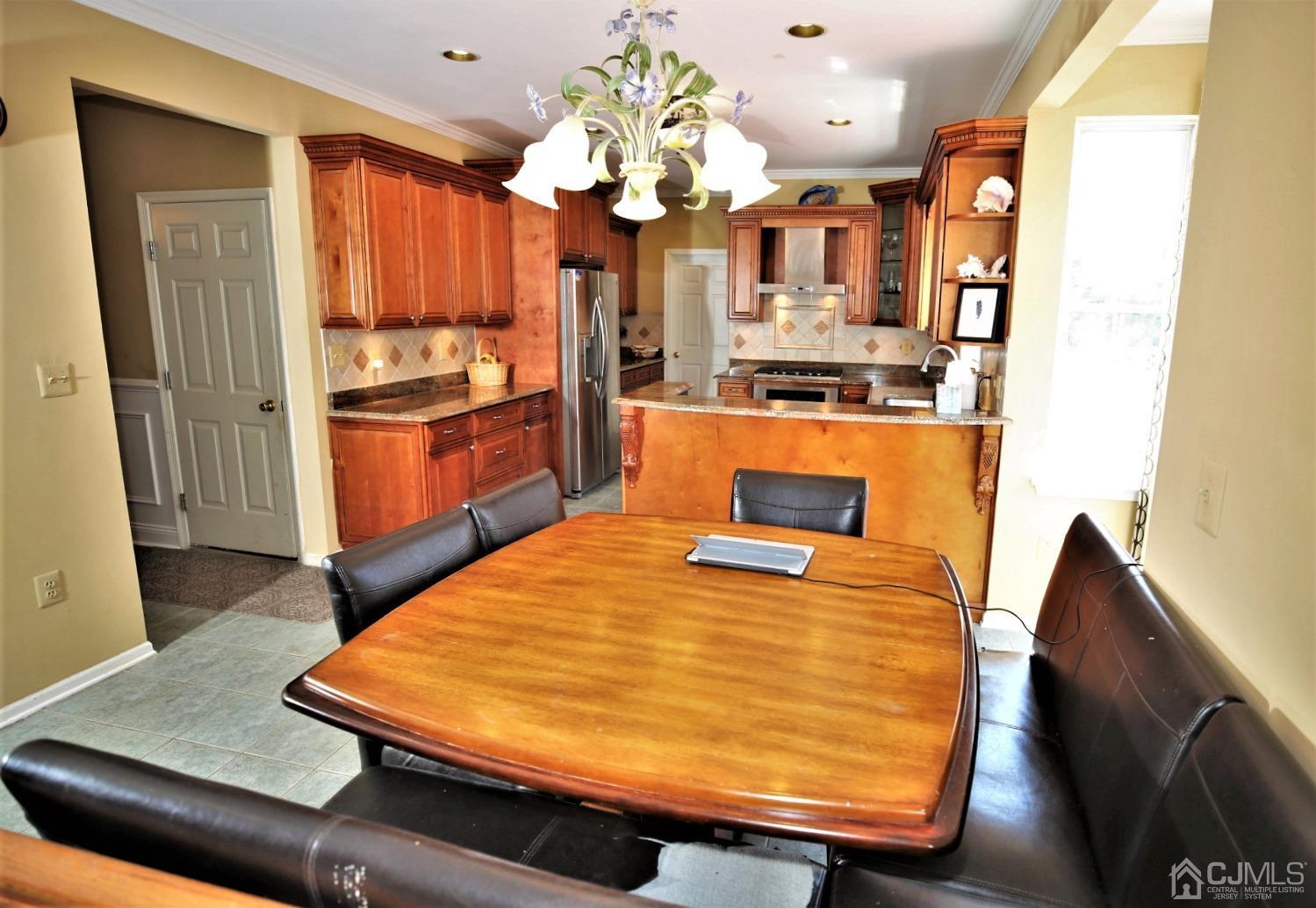 28 Lexington Road Monmouth Junction, NJ 08852 - Photo 14 of 55 a room with stainless steel appliances kitchen island granite countertop wooden cabinets