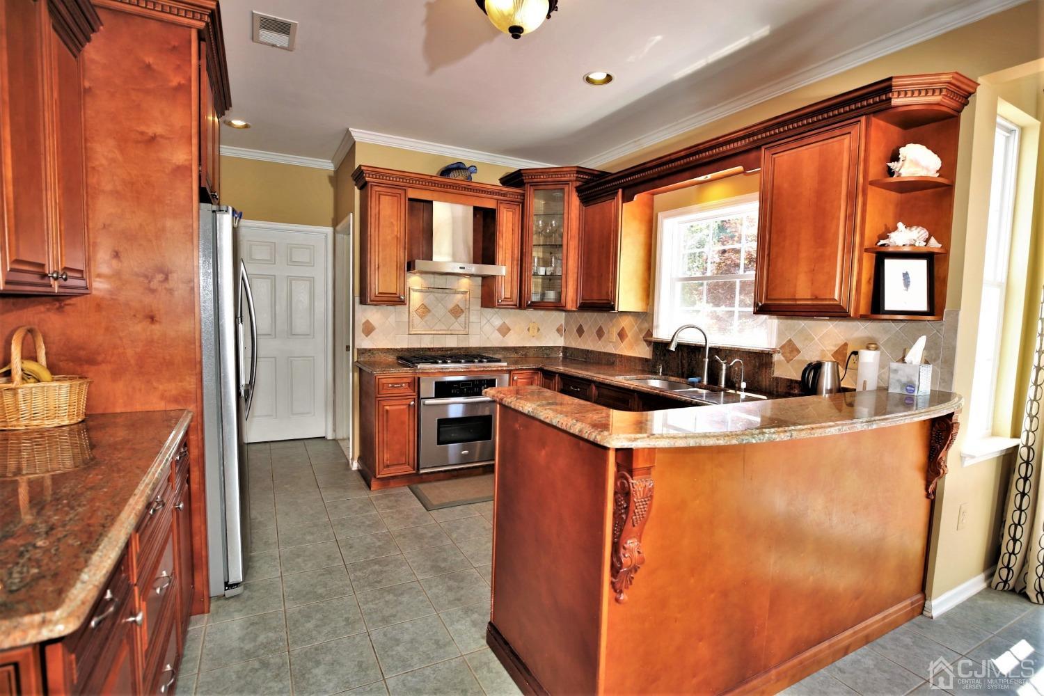 28 Lexington Road Monmouth Junction, NJ 08852 - Photo 15 of 55 a kitchen with stainless steel appliances granite countertop a stove a sink and a refrigerator