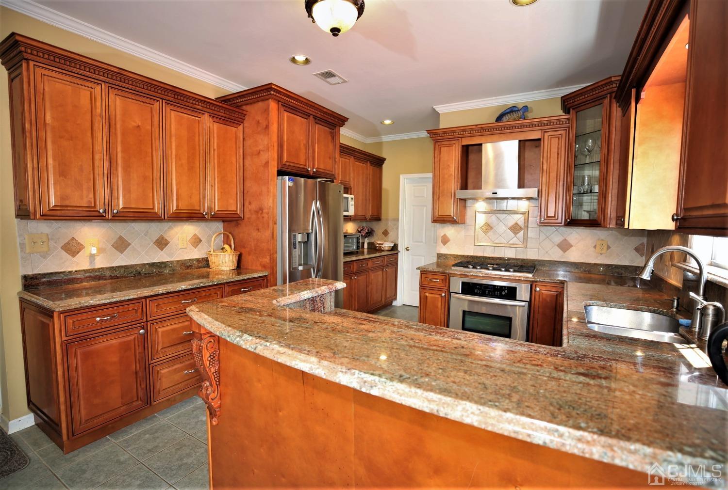 28 Lexington Road Monmouth Junction, NJ 08852 - Photo 16 of 55 a kitchen with stainless steel appliances granite countertop a stove a sink and a refrigerator