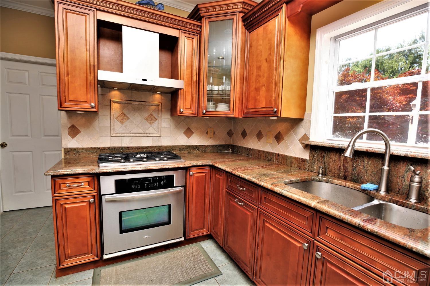 28 Lexington Road Monmouth Junction, NJ 08852 - Photo 17 of 55 a kitchen with granite countertop a sink stainless steel appliances and cabinets