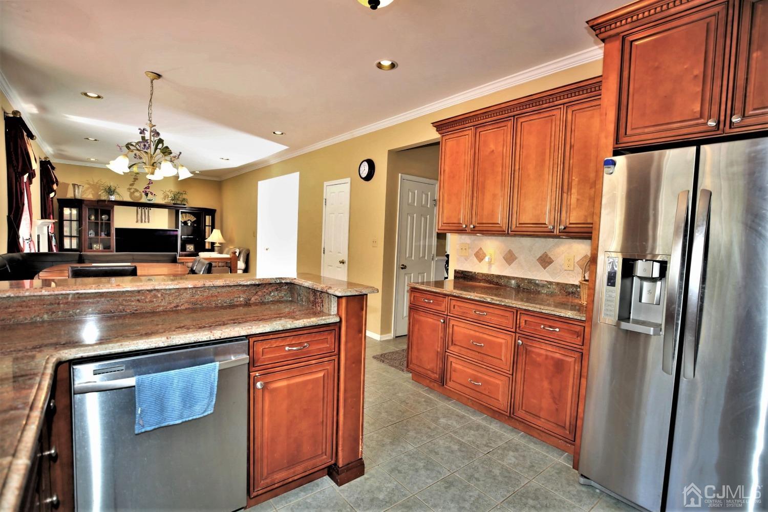 28 Lexington Road Monmouth Junction, NJ 08852 - Photo 19 of 55 a kitchen with stainless steel appliances granite countertop a refrigerator a stove and a sink