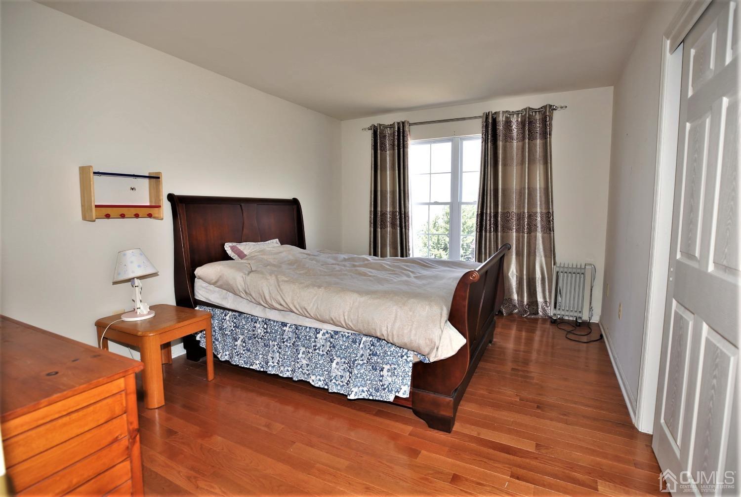 28 Lexington Road Monmouth Junction, NJ 08852 - Photo 36 of 55 a bedroom with a bed a window and wooden floor